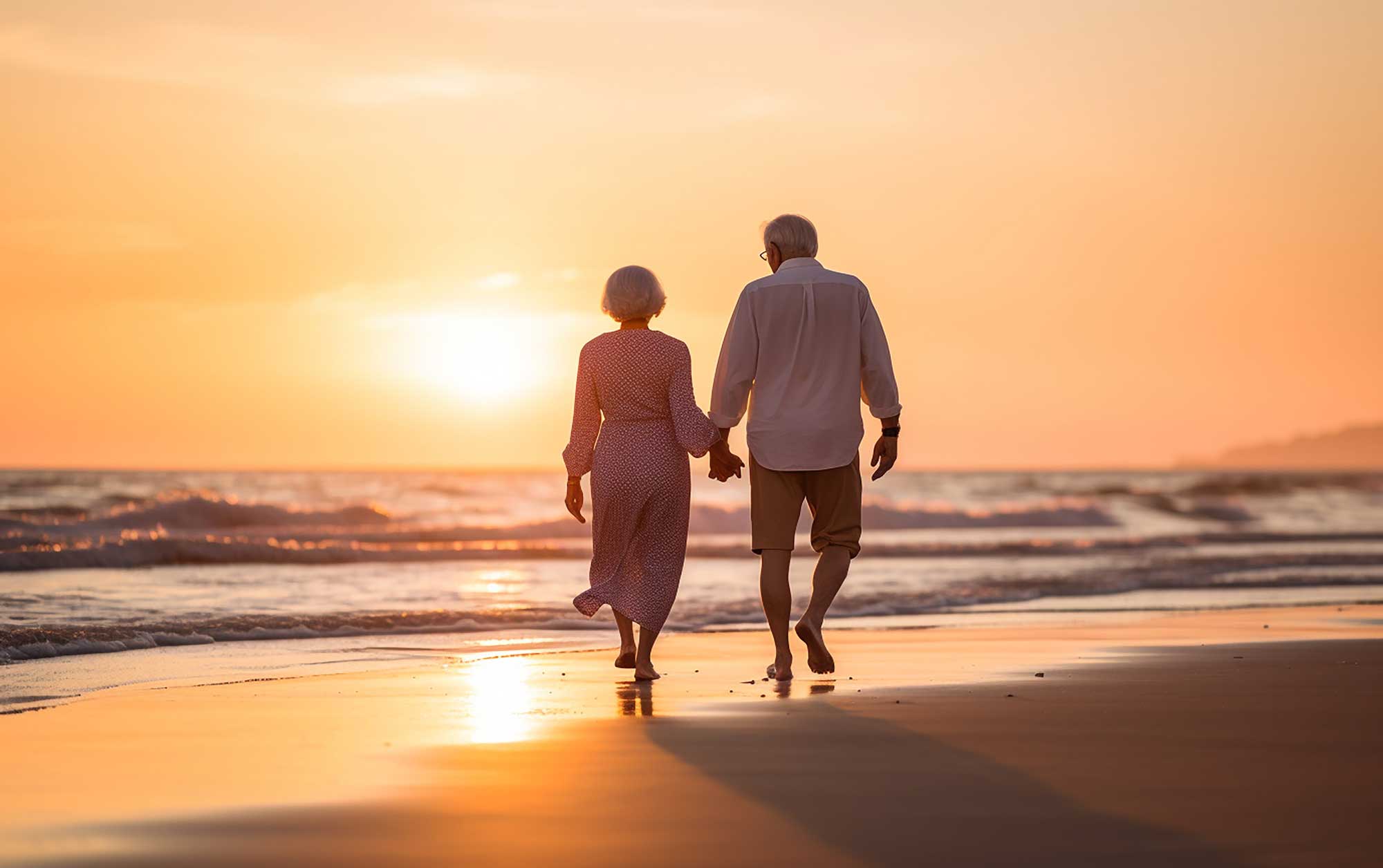 senior couple near the ocean at sunset